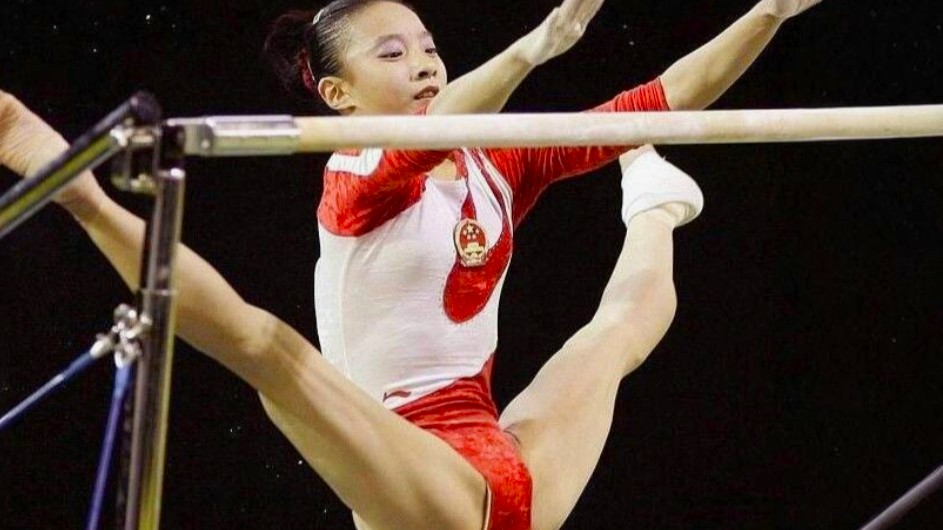 Gymnast in flight between uneven bars